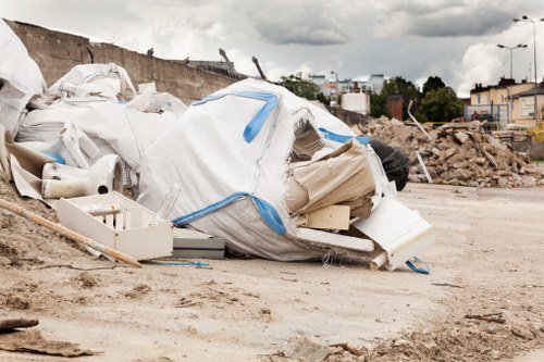 A large skip container placed on a residential street in Herne Hill