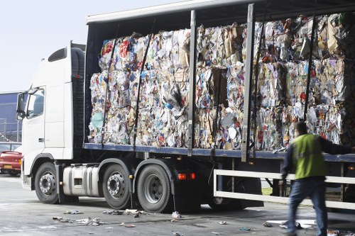 Household waste being loaded into a skip in Herne Hill