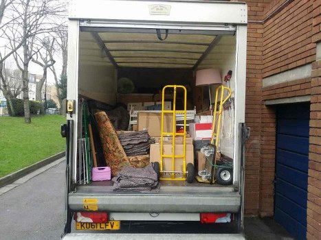 Van and team loading household items in a typical flat clearance